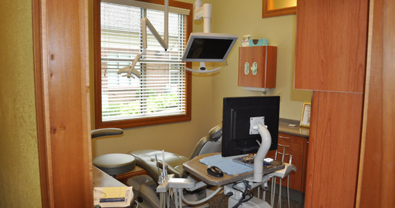 Dental treatment room with exam chair and viewing monitors