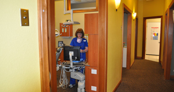 Dental team member using computer in treatment room