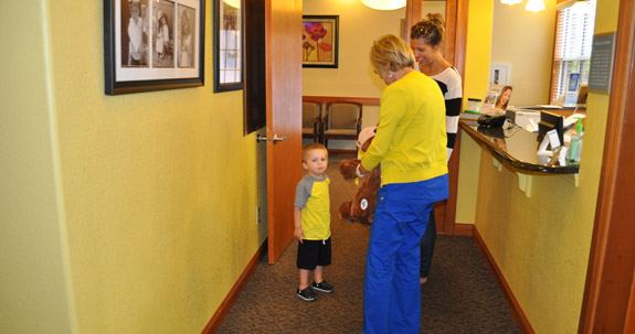 Two women and small boy standing in reception area