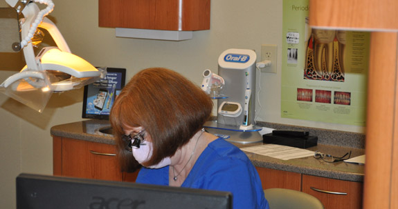 Dental team member wearing a medical mask in treatment room