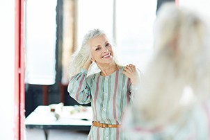 Woman flipping her hair in the mirror