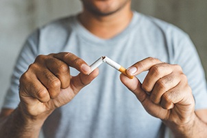 Closeup of patient breaking cigarette