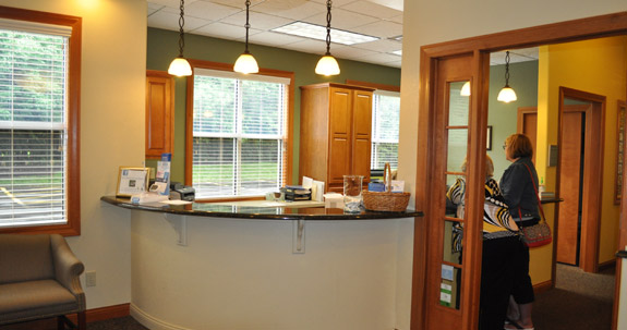 Two patients standing at welcome desk