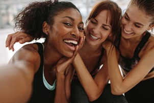 friends smiling and taking a picture together