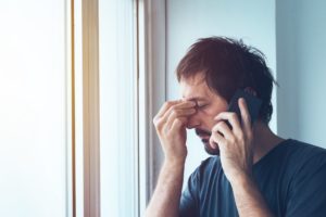 worried person on the phone with their emergency dentist