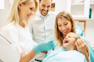 Child smiling at family dentist in Centerville