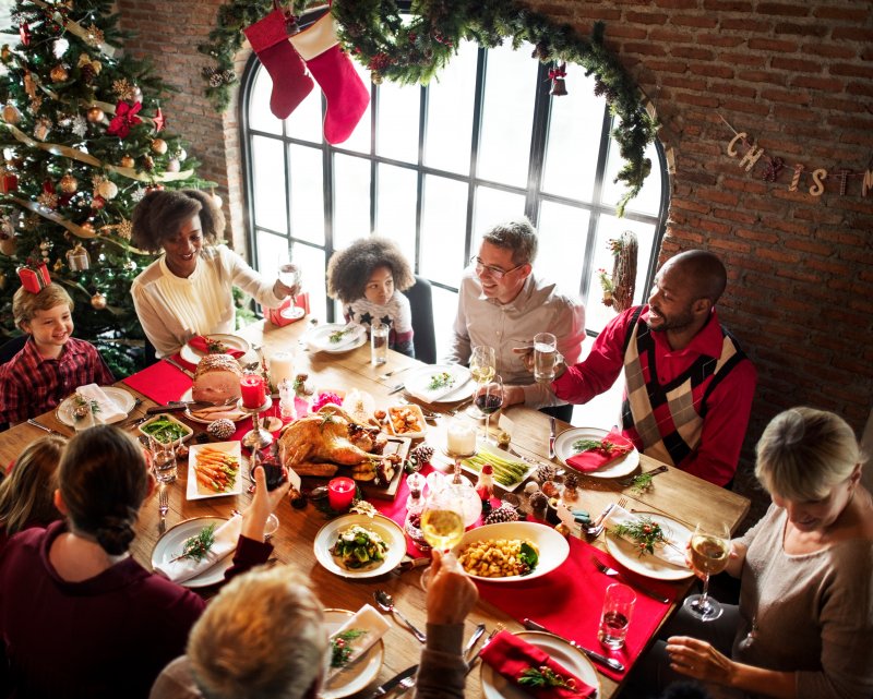 A family enjoying Thanksgiving after the dad’s dental implants were successful