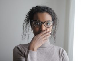 Woman covering her mouth with her hand