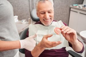 Man learning how he can care for his dentures
